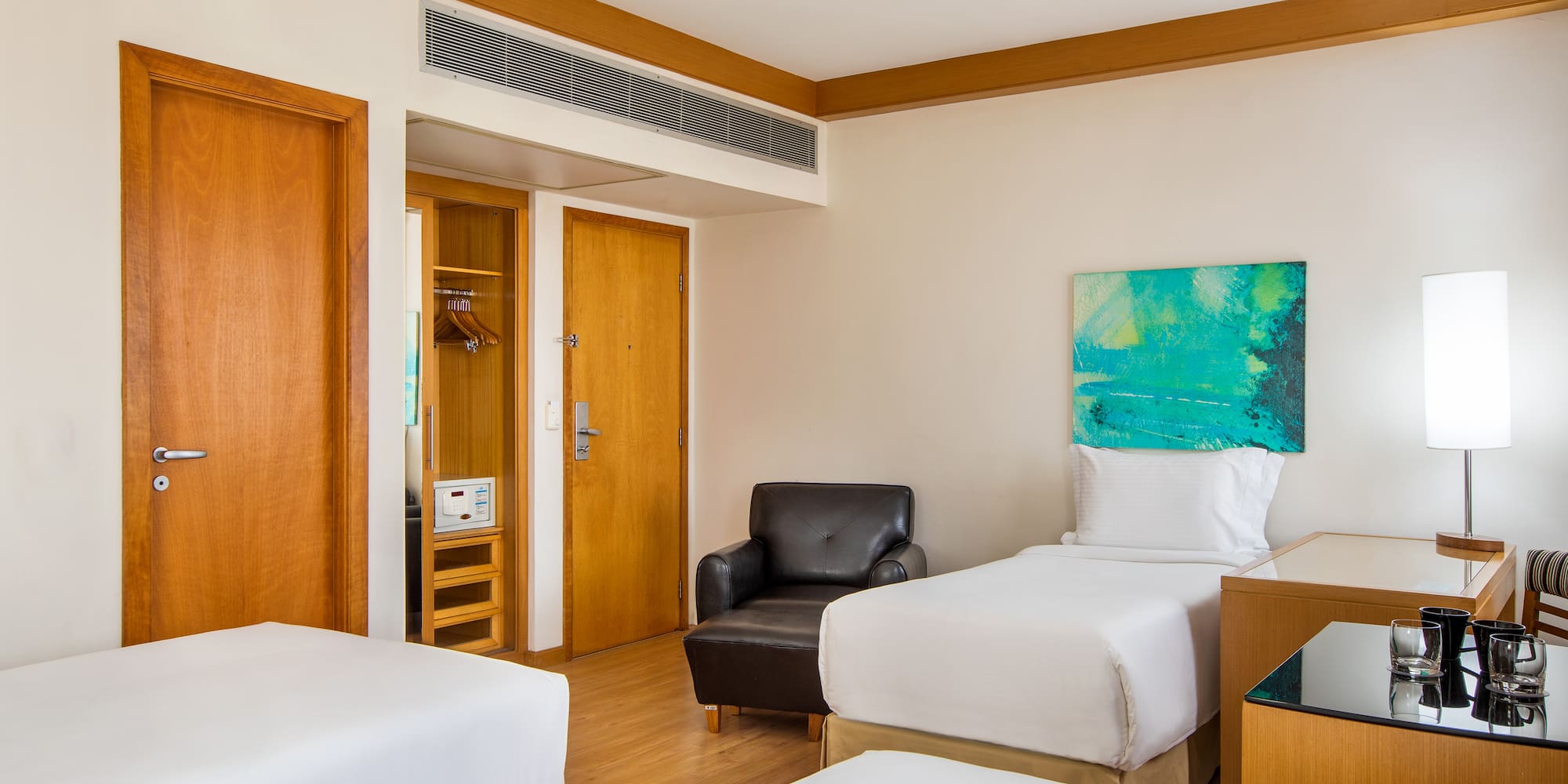 a room with two beds and a chair