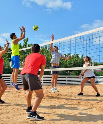 a group of people playing volleyball
