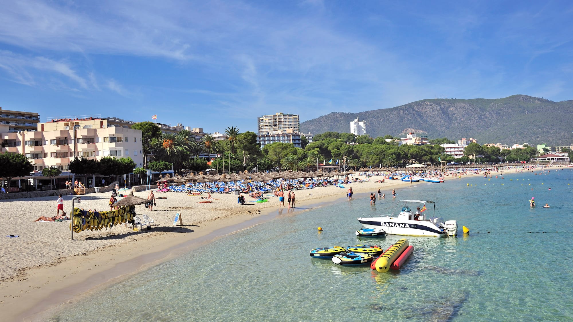 a beach with boats and people on it