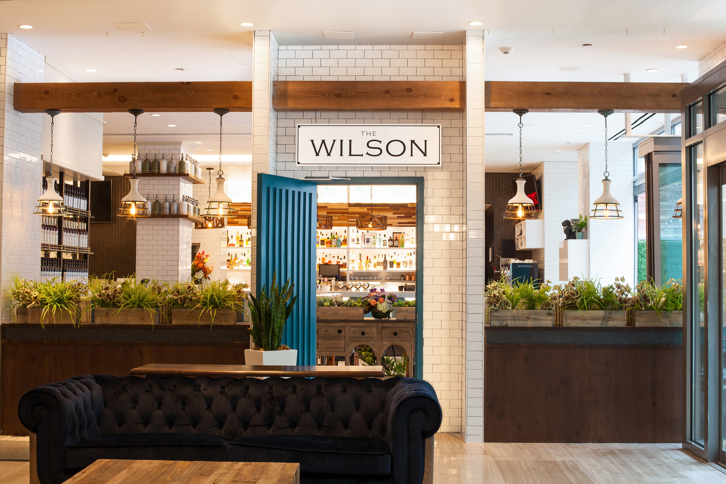 The Wilson restaurant & bar entrance, modern design, blue lounge sofa.