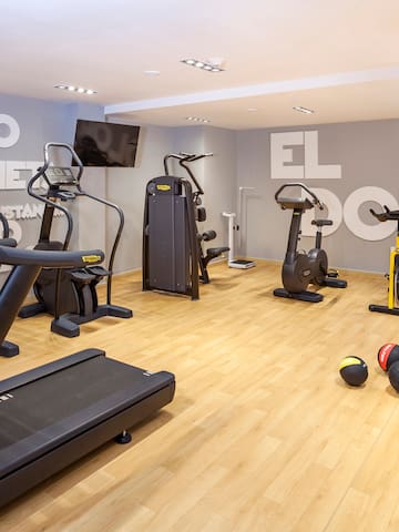 a room with exercise equipment and a wall with white letters