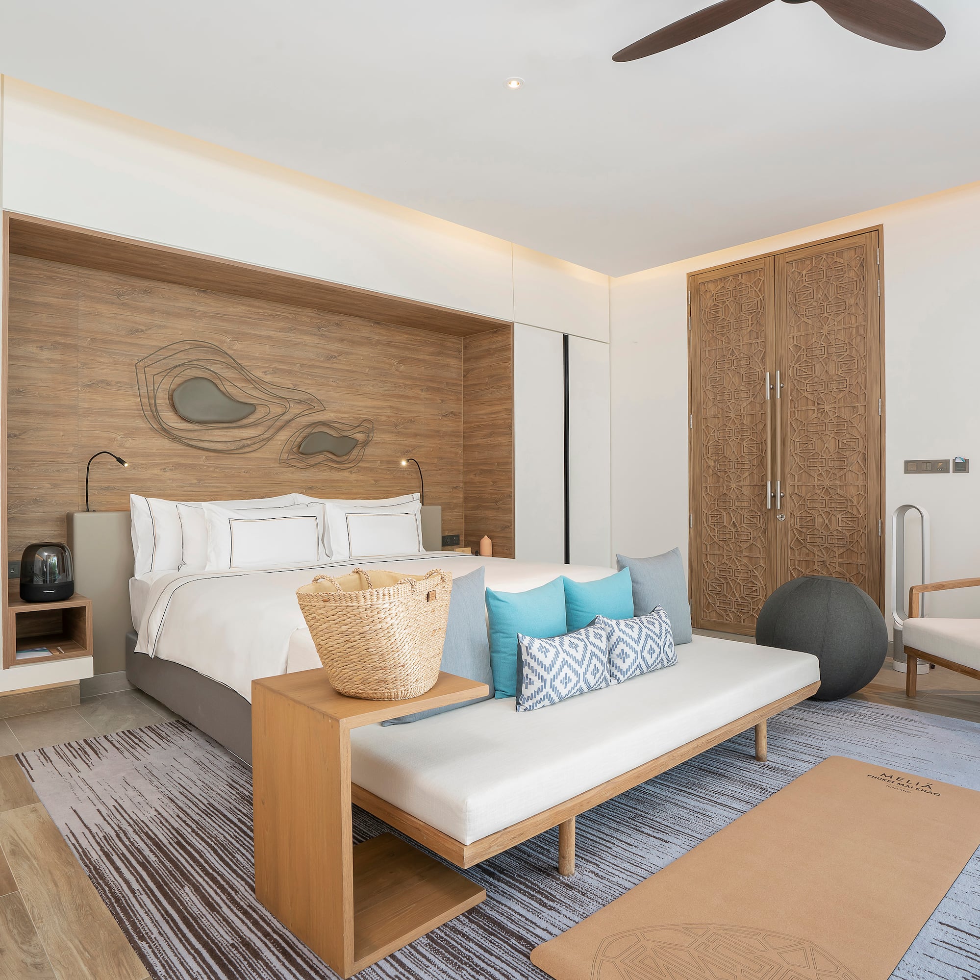 a room with a bed and a fan