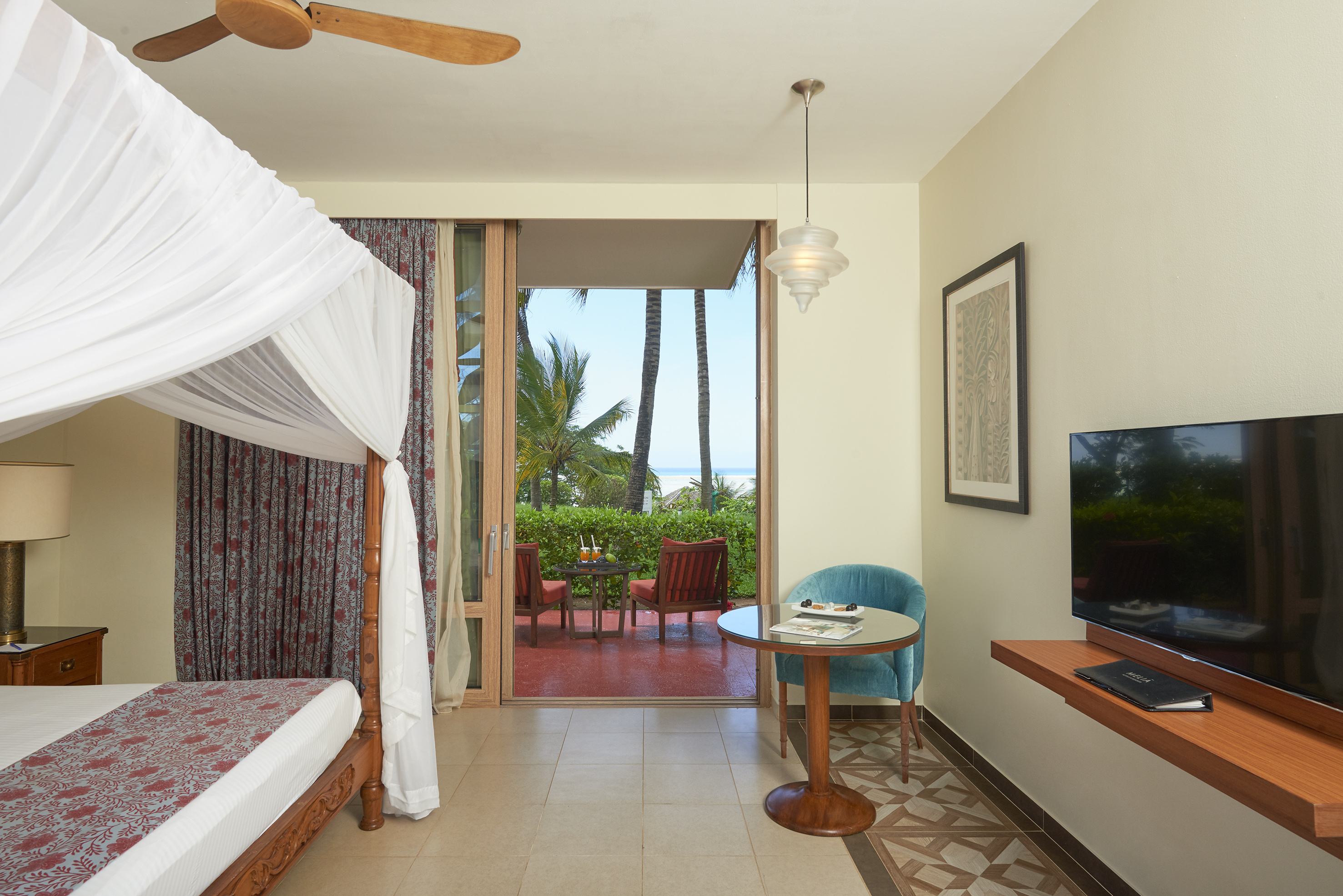 a room with a bed and a television