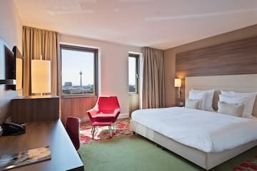 a room with a bed and a desk and chairs