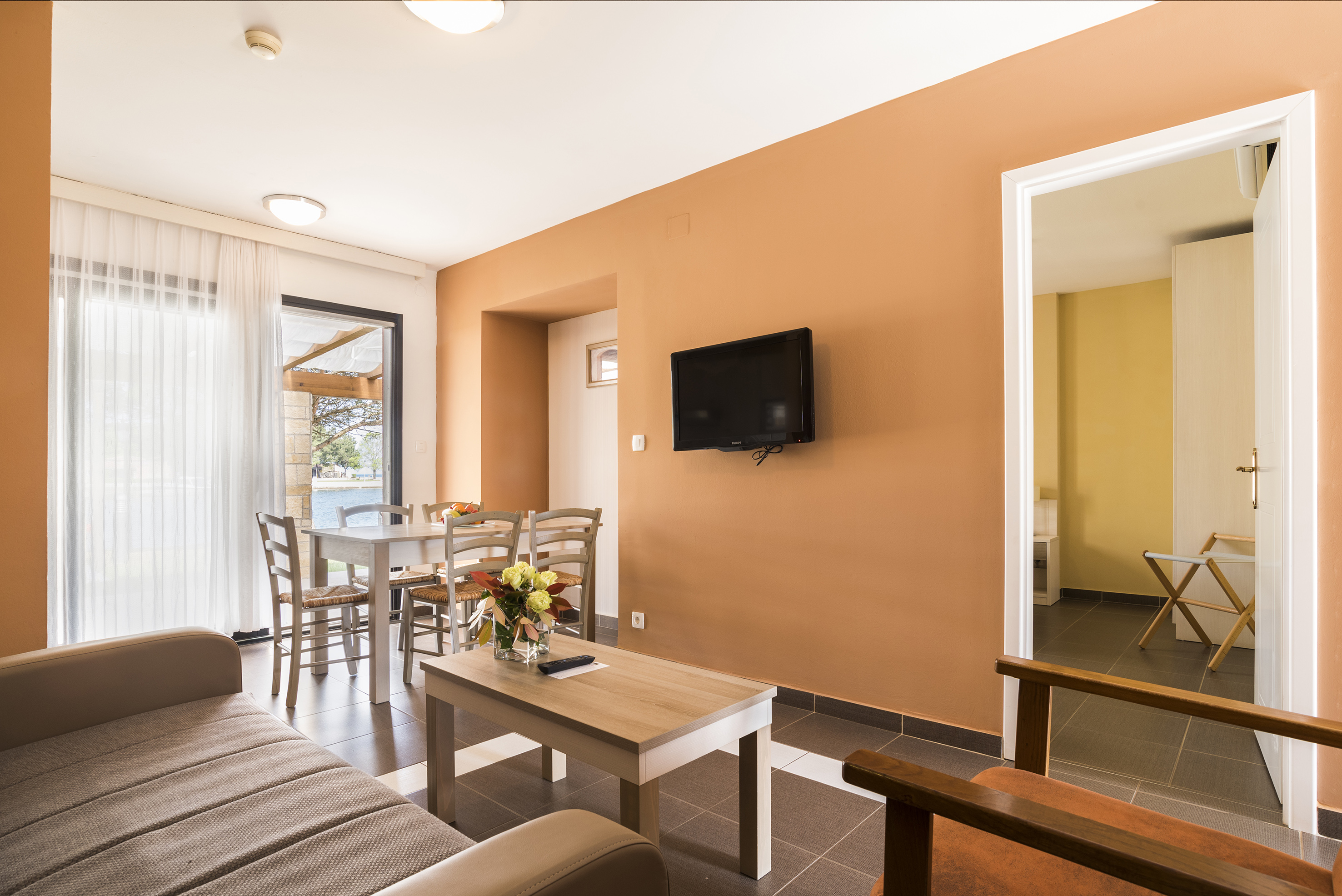 a living room with a tv and table