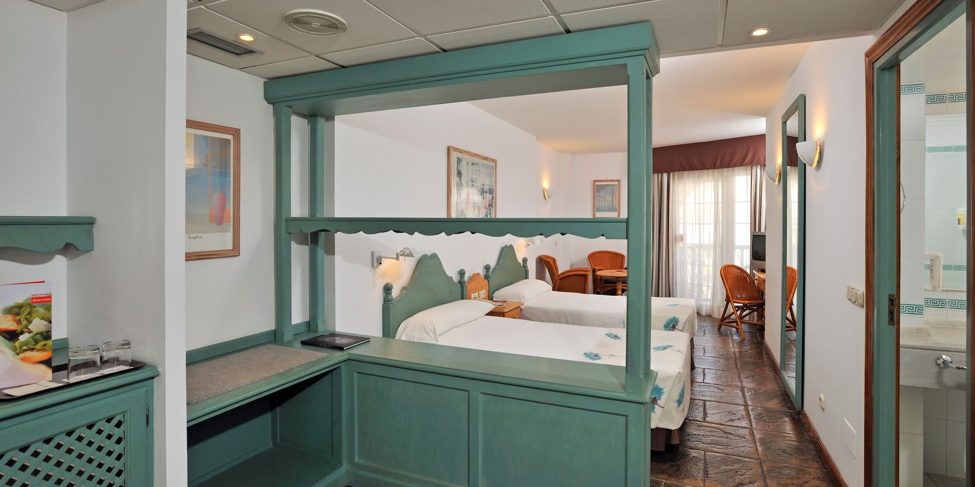 a room with two beds and a table