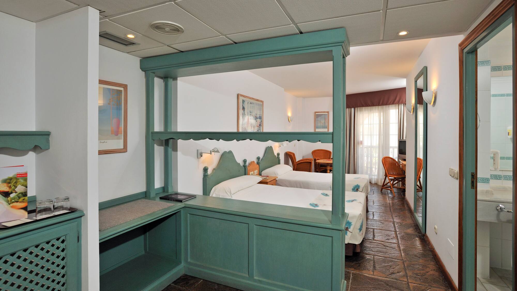 a room with two beds and a table
