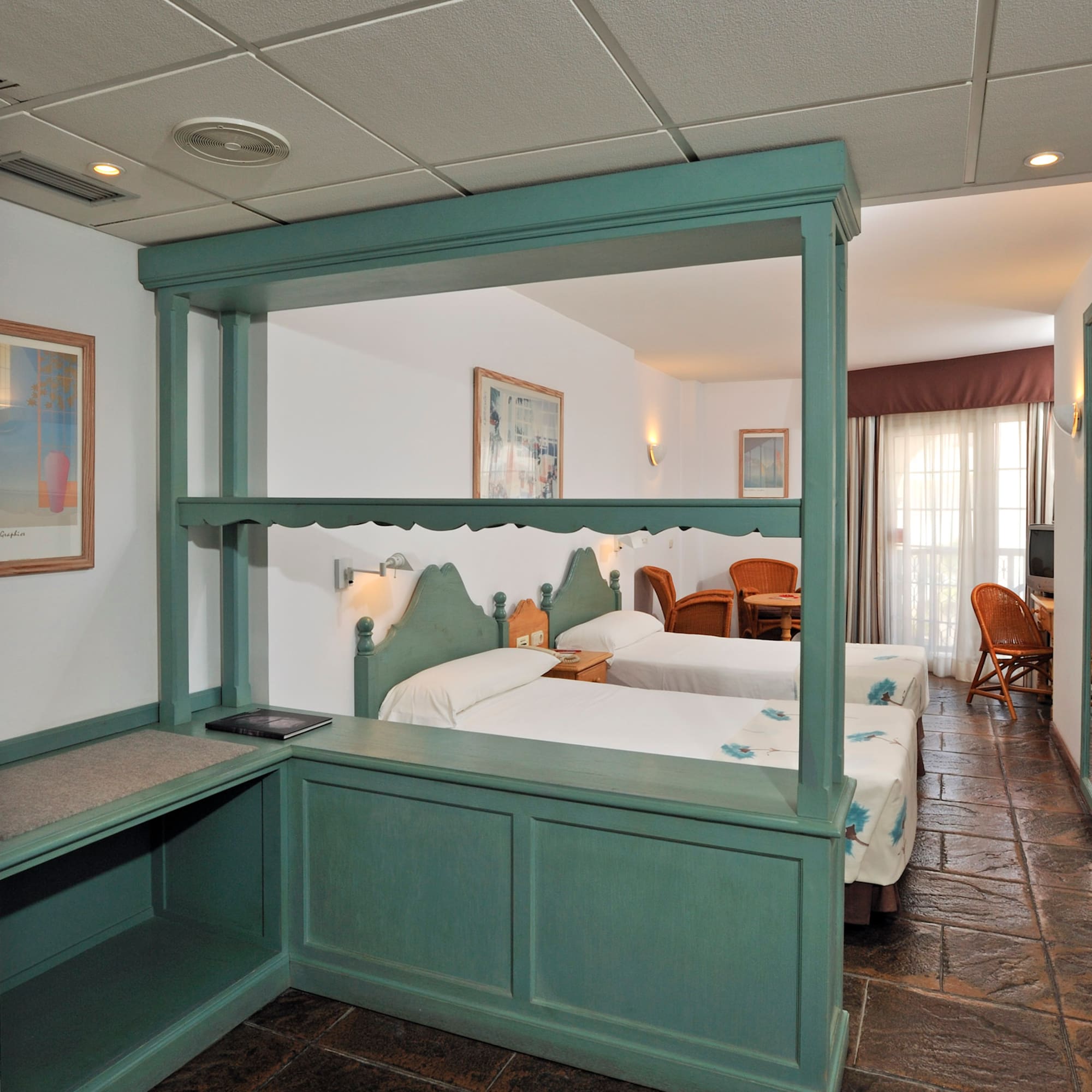 a room with two beds and a table