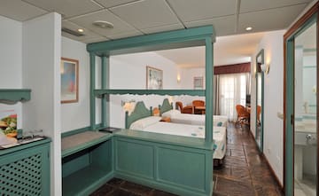 a room with two beds and a table