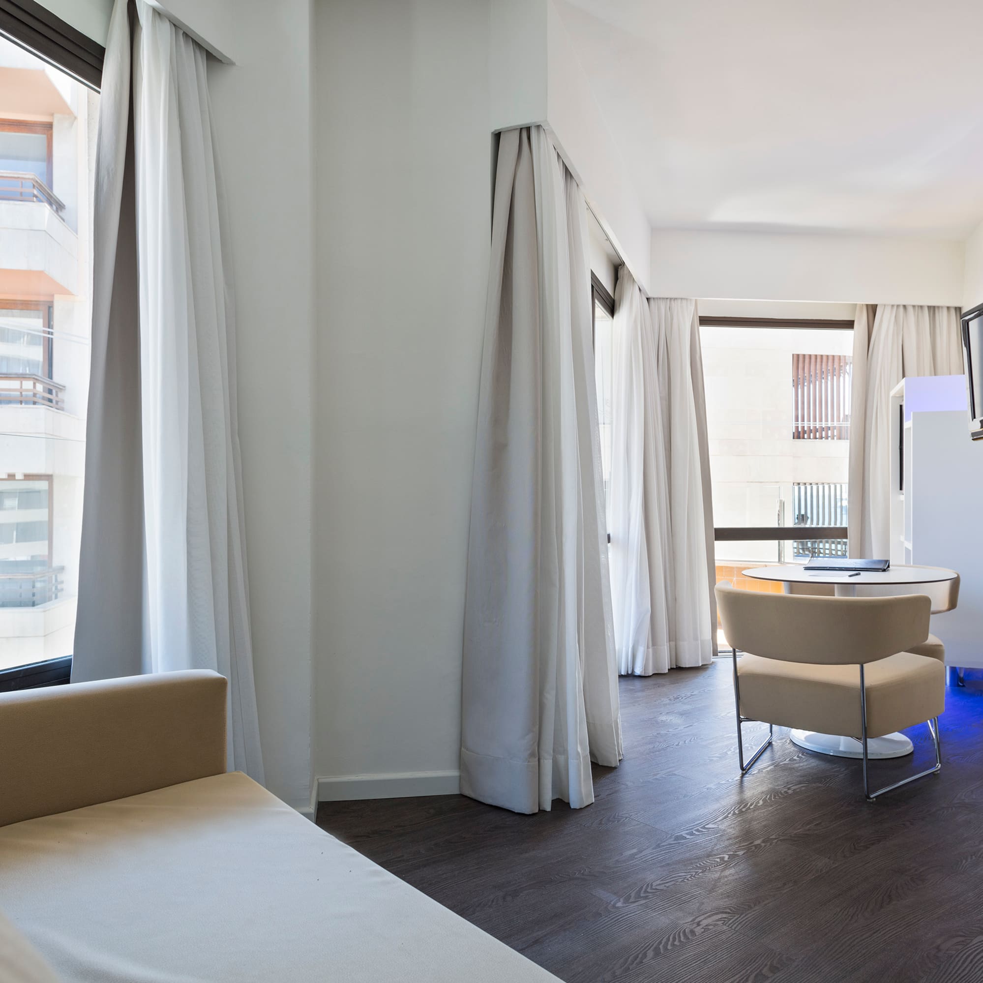 a room with a bed and a television