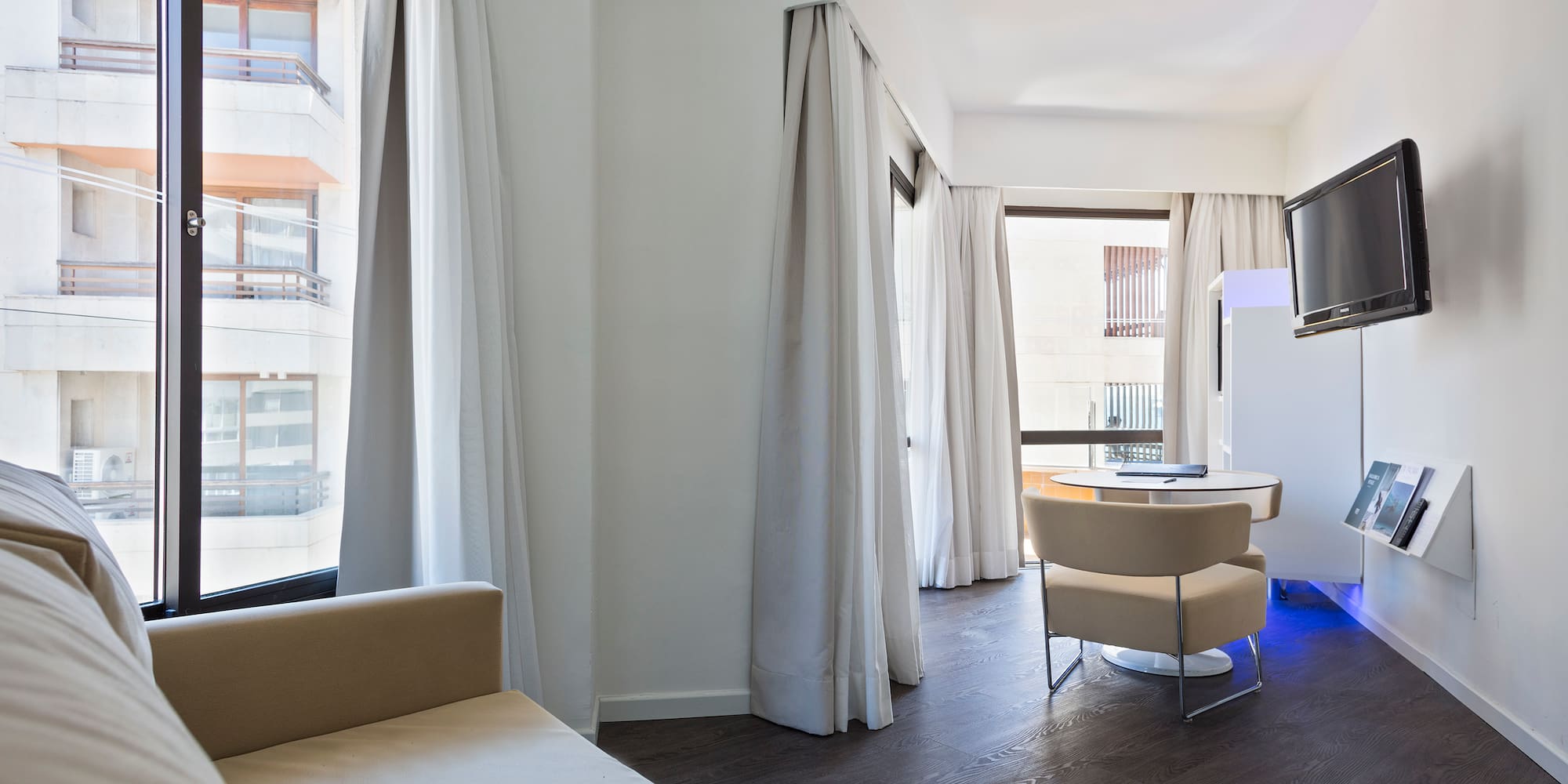 a room with a bed and a television