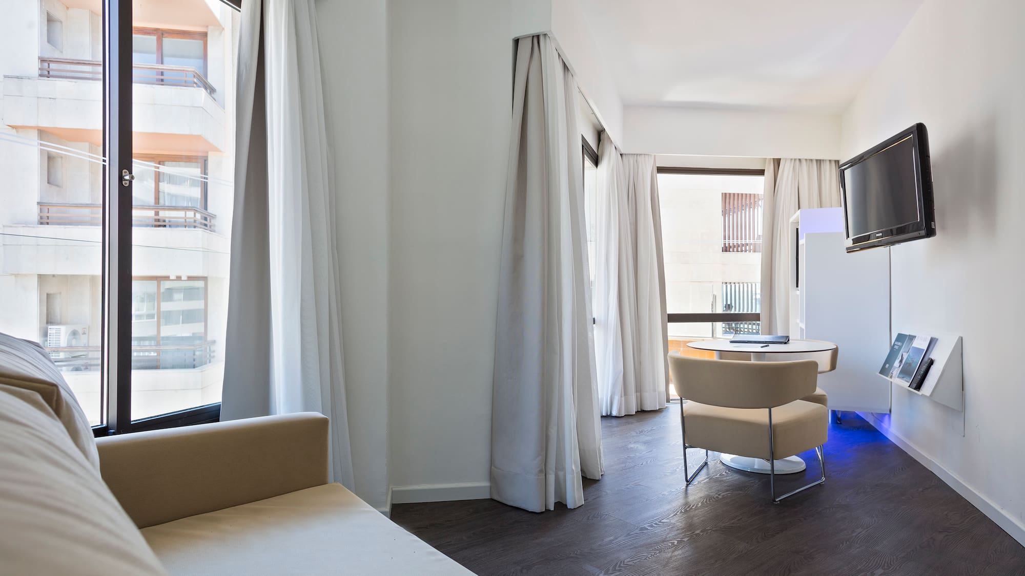 a room with a bed and a television