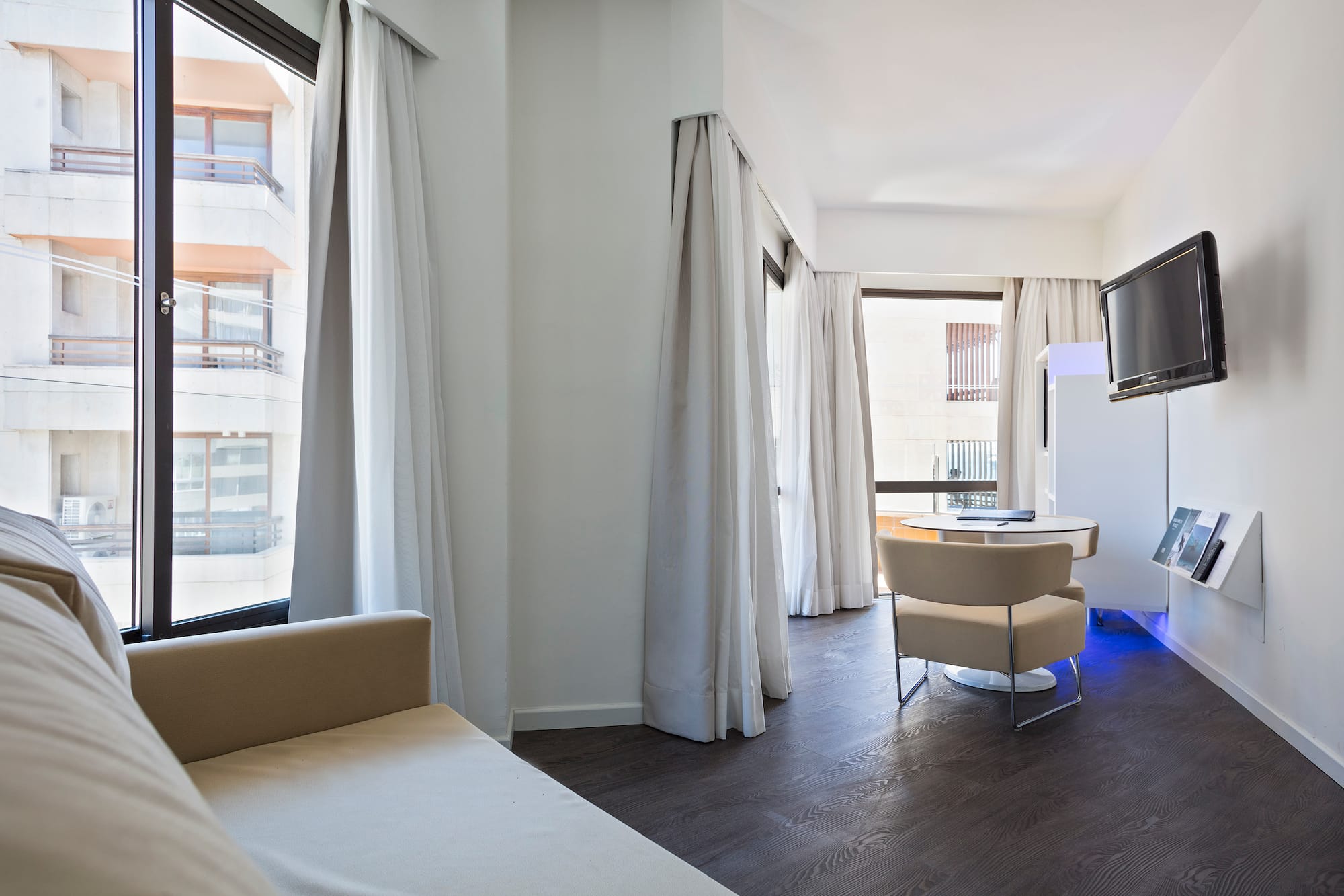 a room with a bed and a television