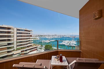 a balcony with a view of a city and water