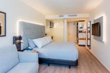 a bedroom with a bed and a couch
