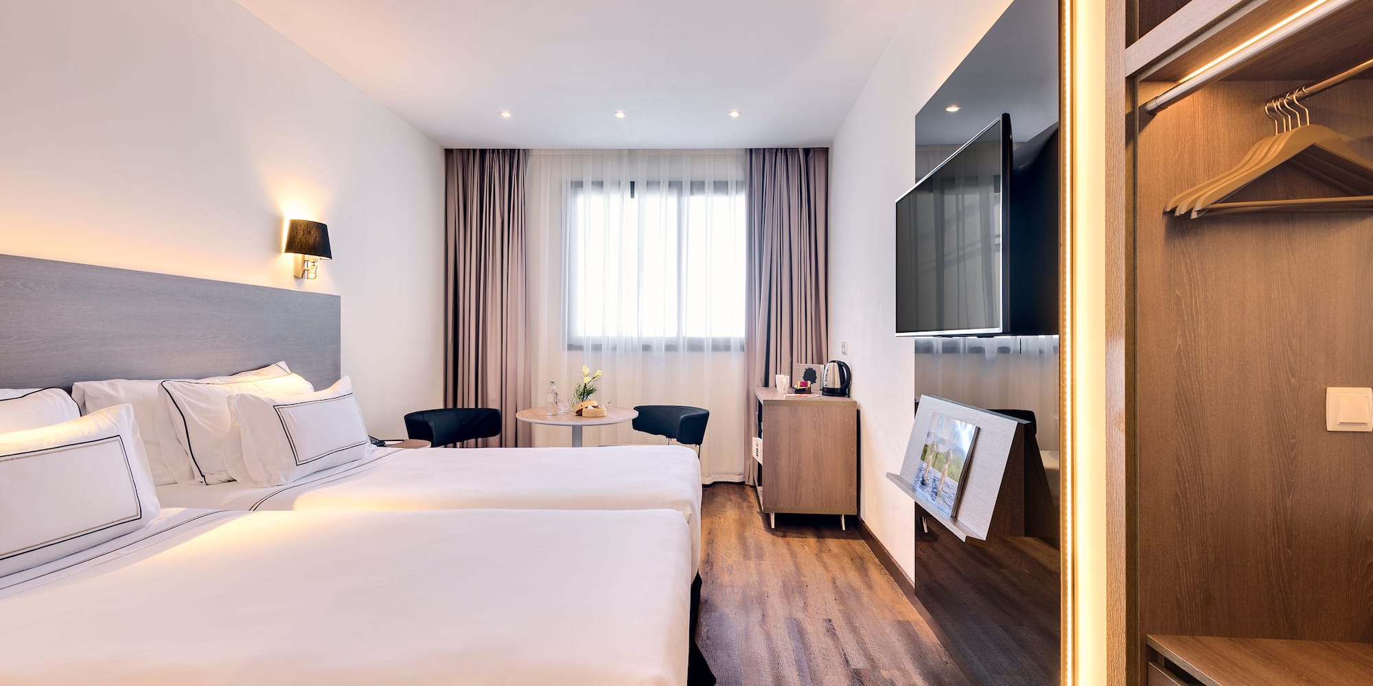 a room with two beds and a television