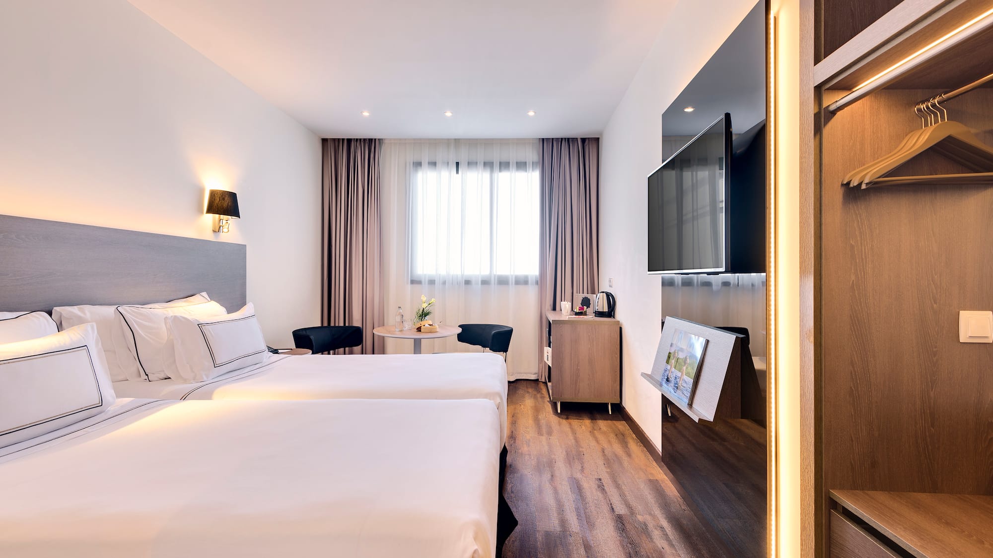 a room with two beds and a television