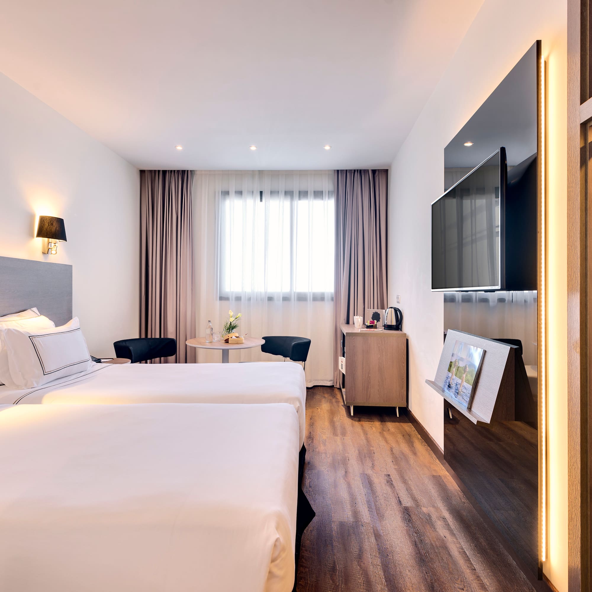 a room with two beds and a television