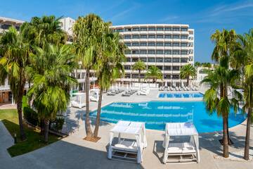 a pool with palm trees and chairs