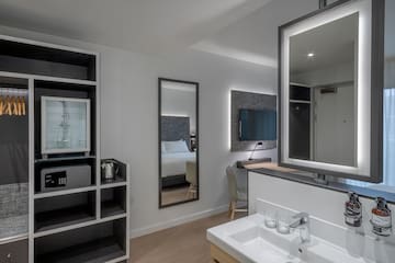 a bathroom with a mirror and a tv