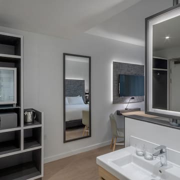a bathroom with a mirror and a tv