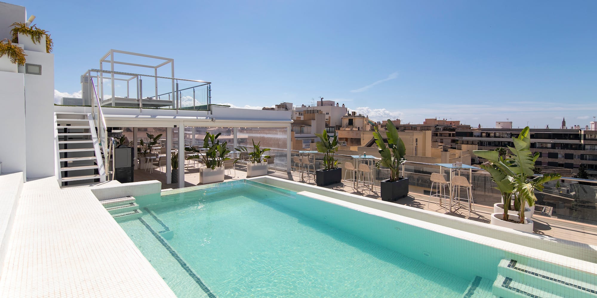 a pool with a rooftop view of a city