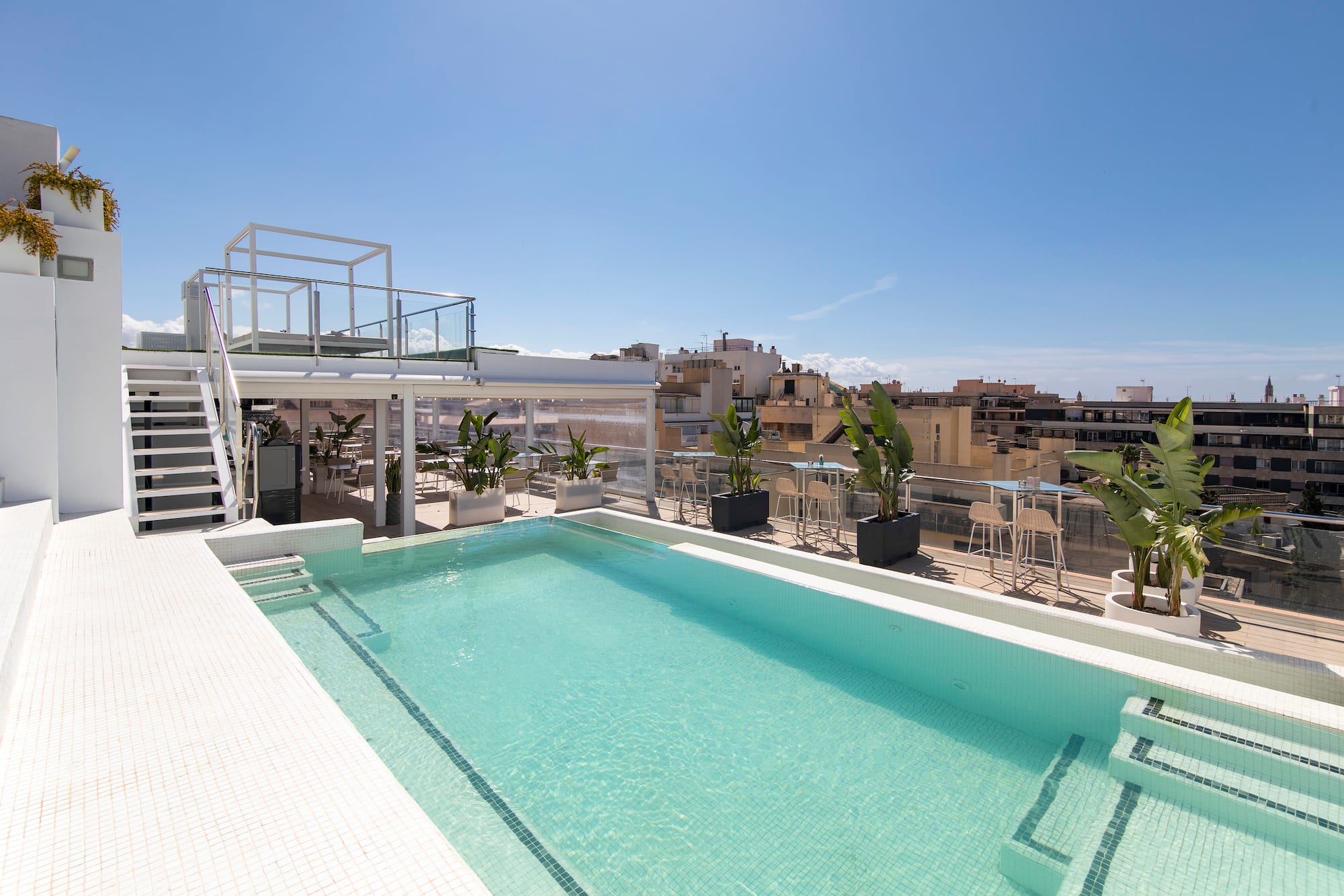 a pool with a rooftop view of a city