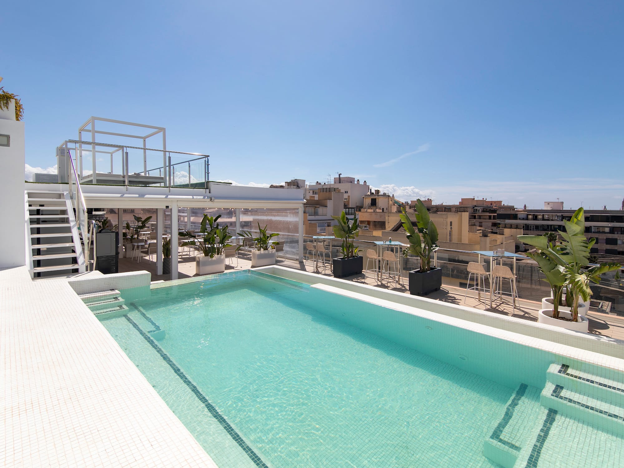 a pool with a rooftop view of a city