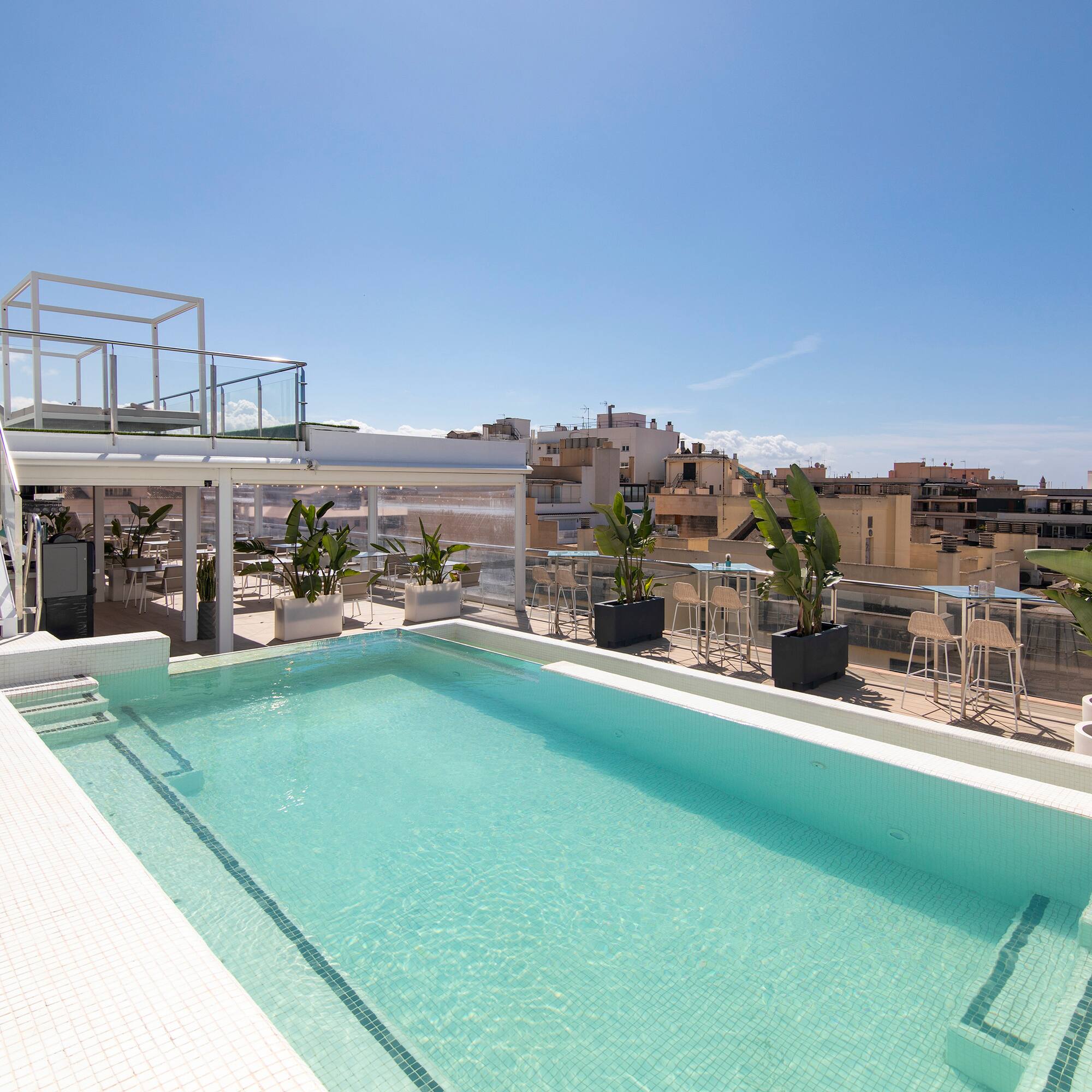 a pool with a rooftop view of a city