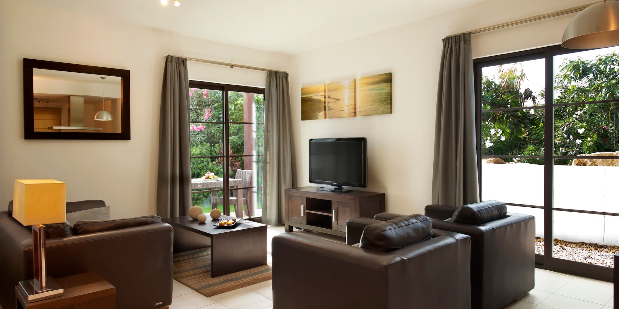 a living room with leather furniture and a television