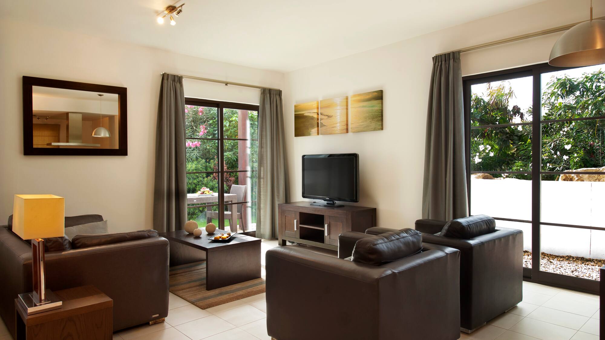 a living room with leather furniture and a television