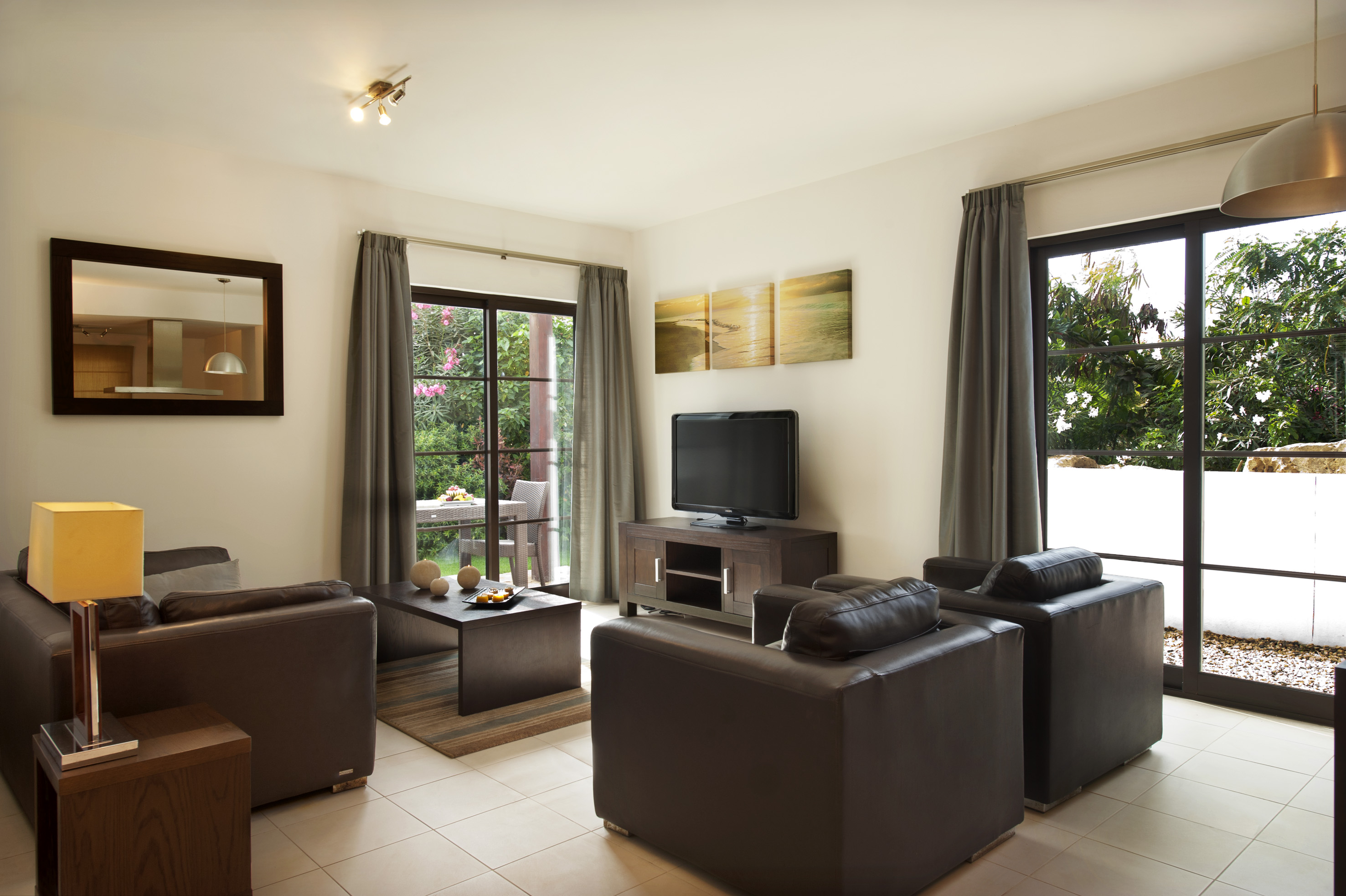 a living room with leather furniture and a television