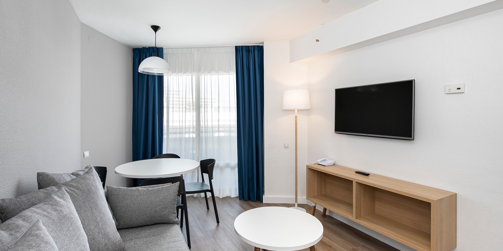 a room with a couch and table and tv