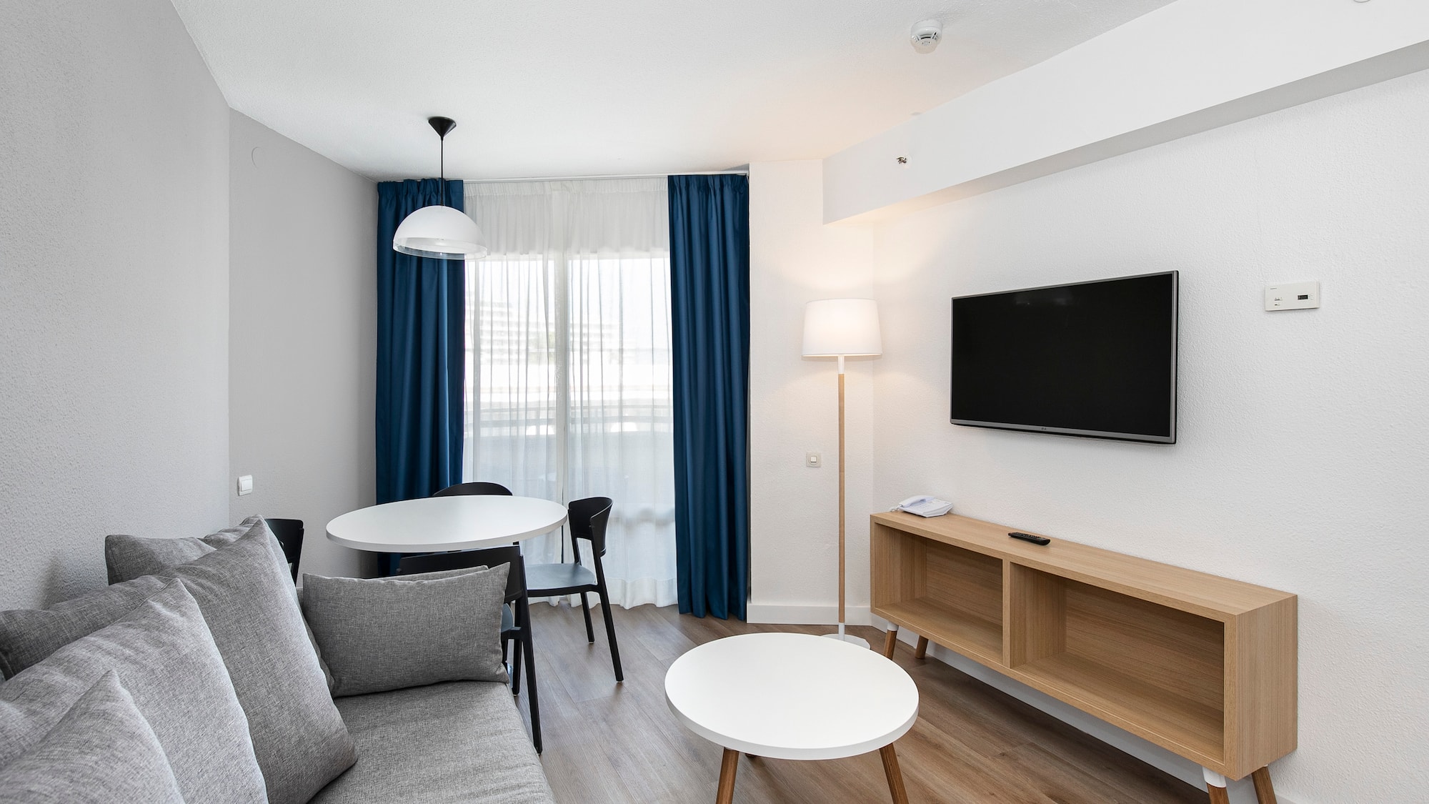 a room with a couch and table and tv