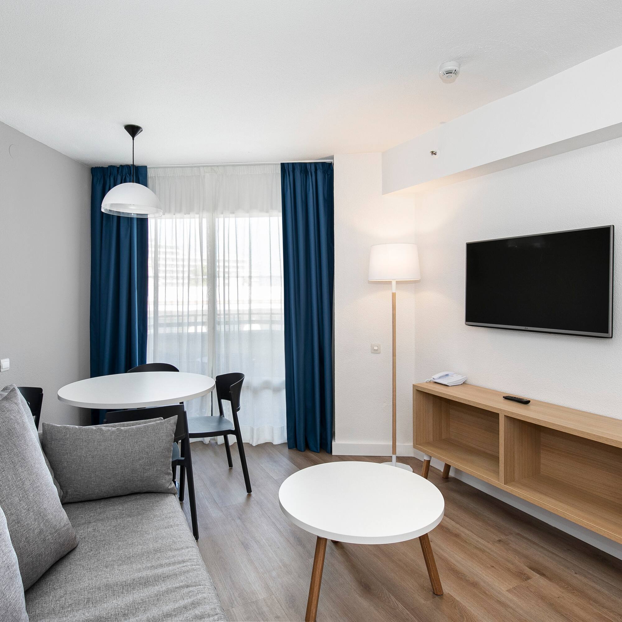 a room with a couch and table and tv