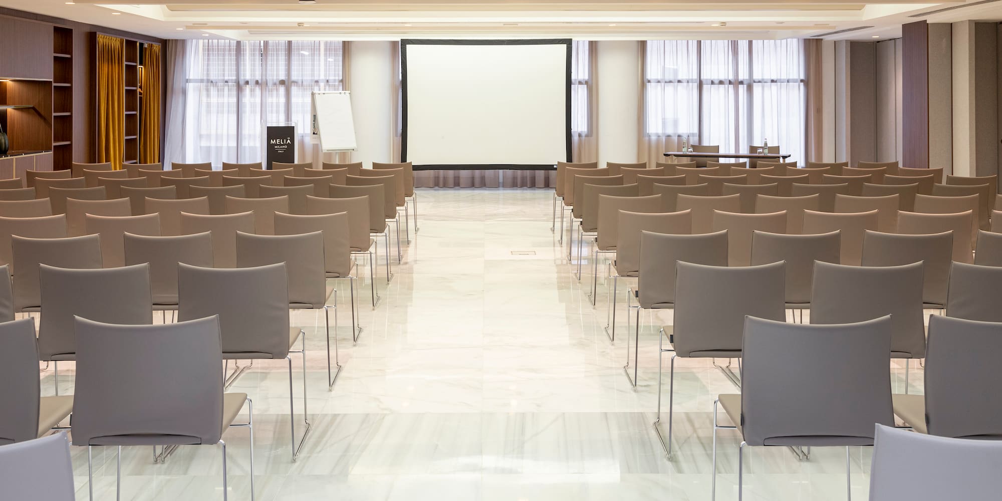 a room with chairs and a projector screen