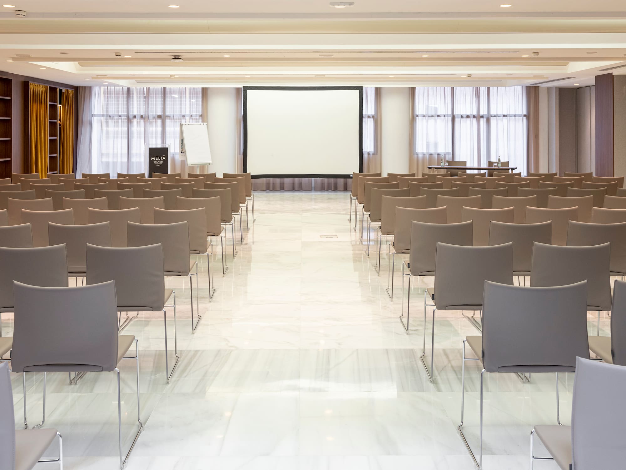 a room with chairs and a projector screen