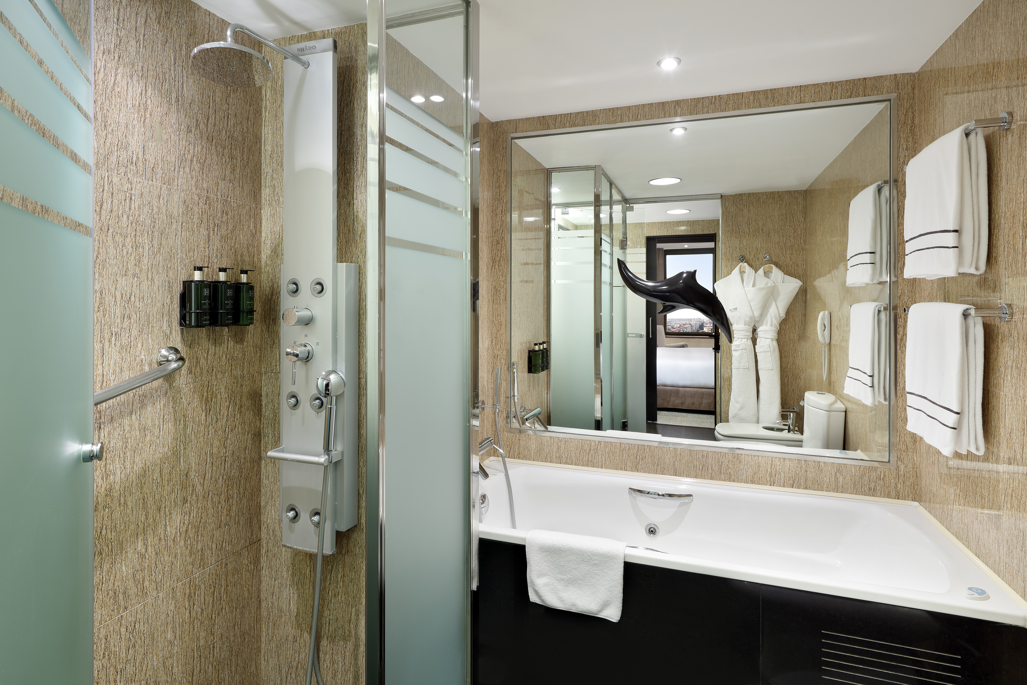 Luxury hotel bathroom with walk-in shower, multi-jet panel, and bathtub.