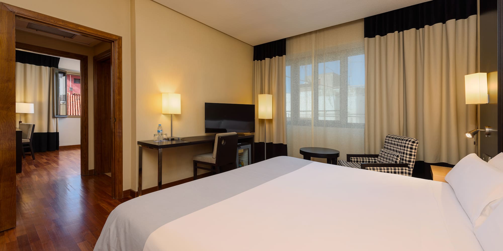 a room with a bed and a desk and chair