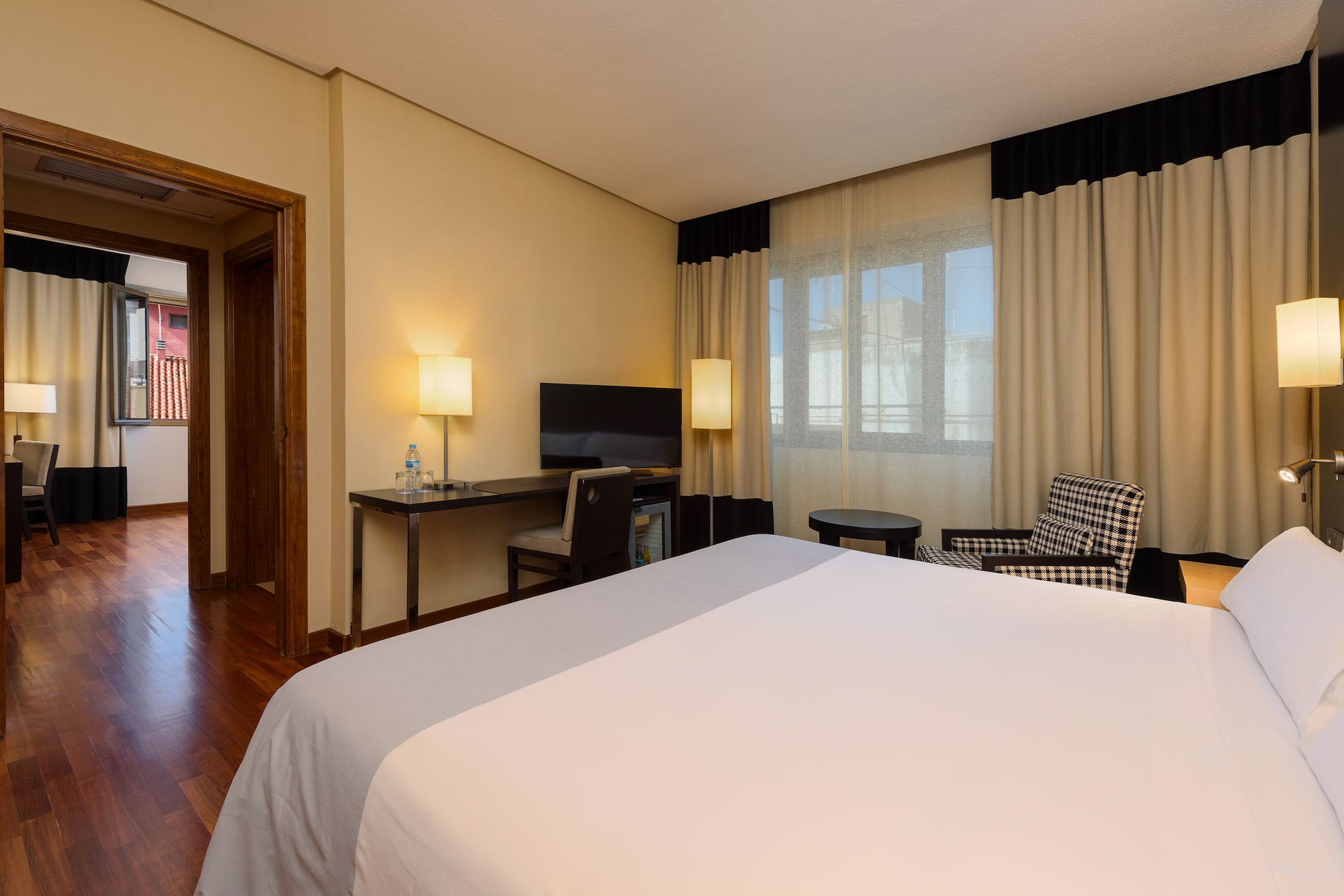 a room with a bed and a desk and chair