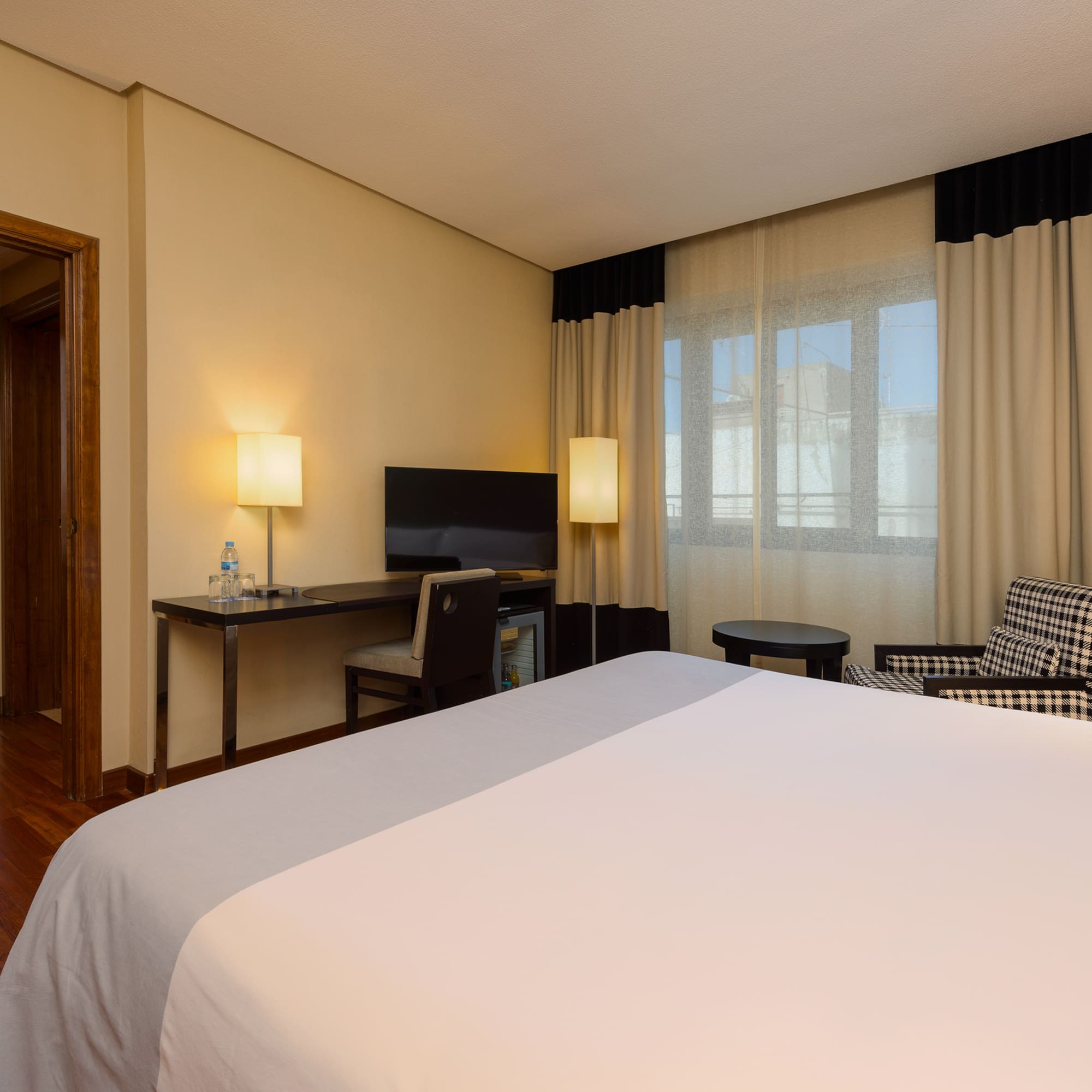 a room with a bed and a desk and chair