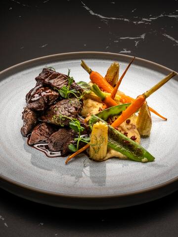 a plate of food on a black surface