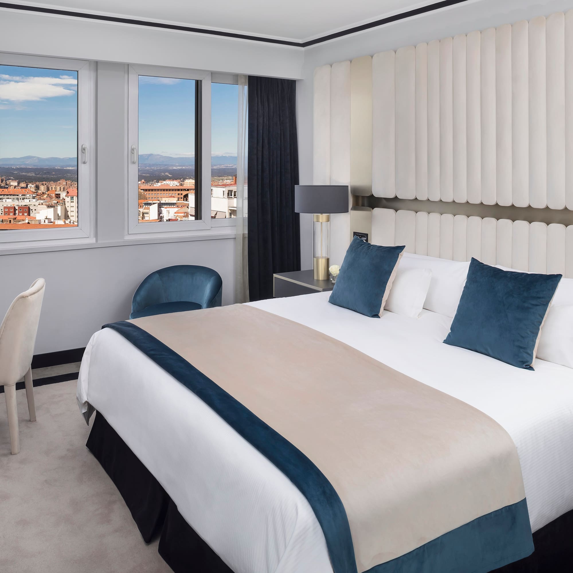 a bedroom with a bed and chairs