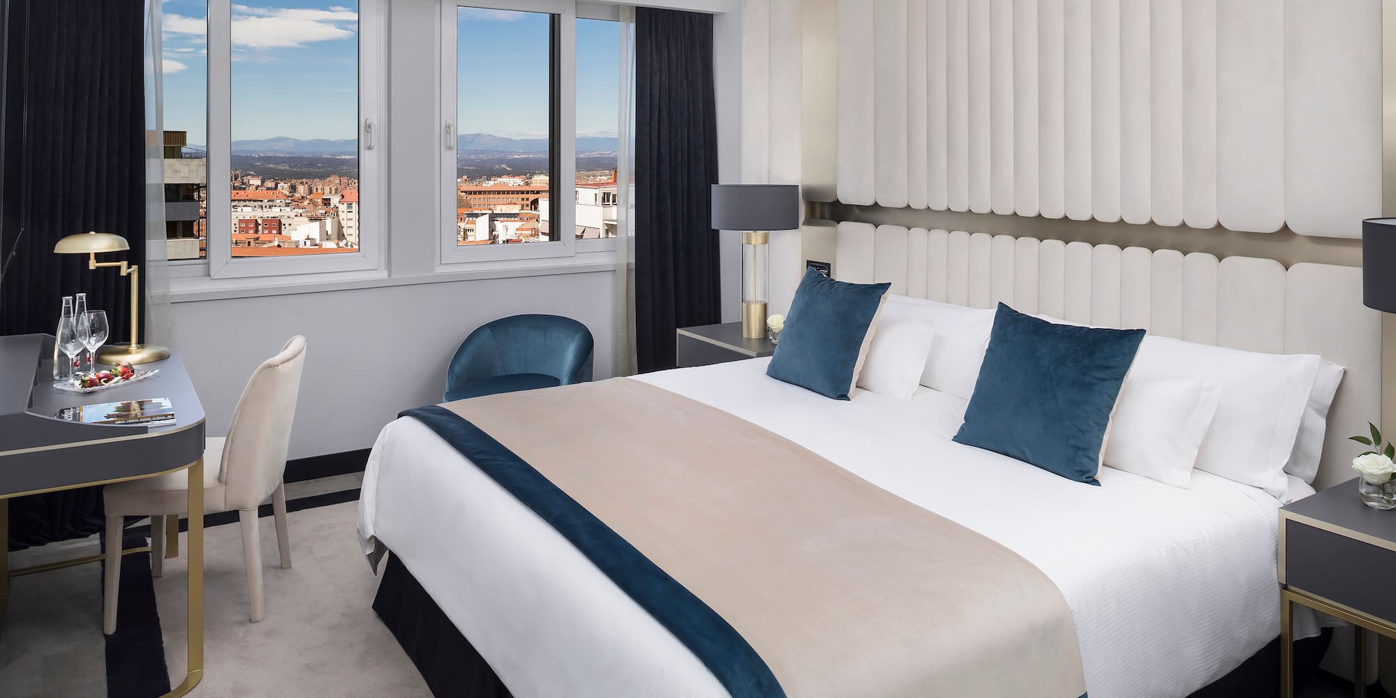 a bedroom with a bed and chairs