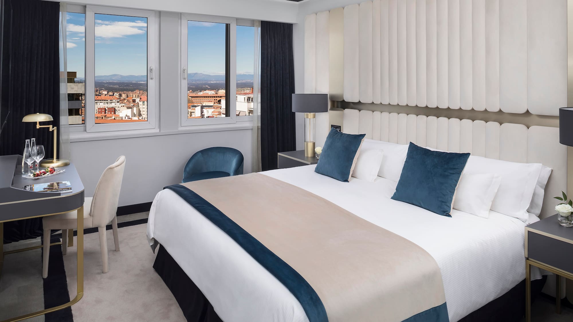 a bedroom with a bed and chairs