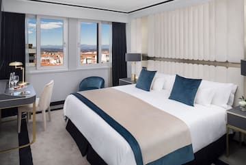 a bedroom with a bed and chairs