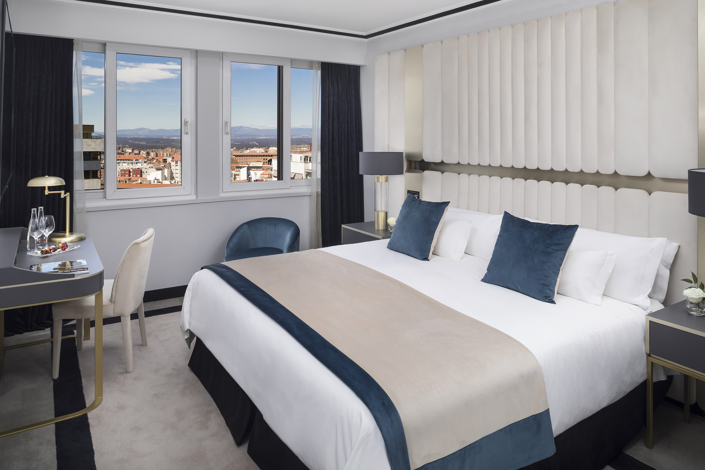 a bedroom with a bed and chairs