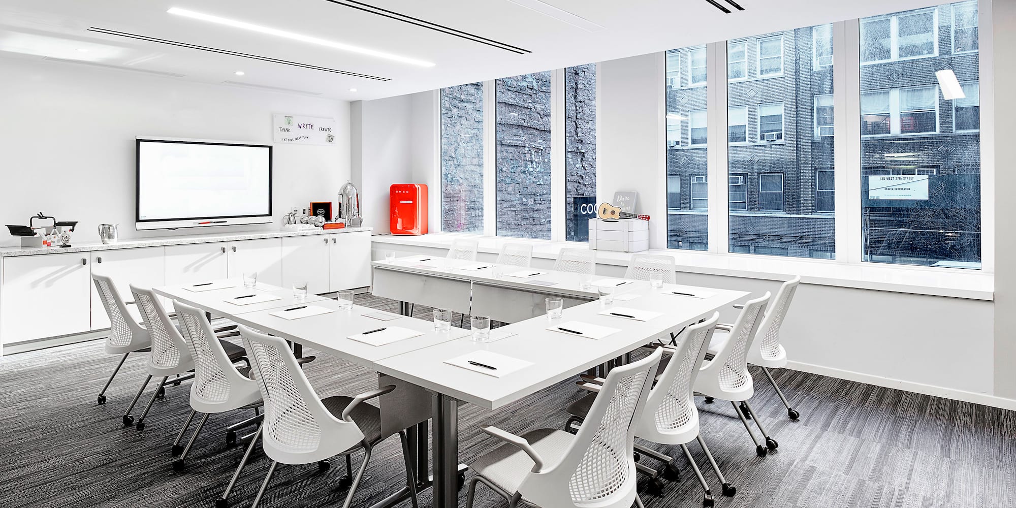a room with white tables and chairs