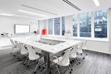 a room with white tables and chairs