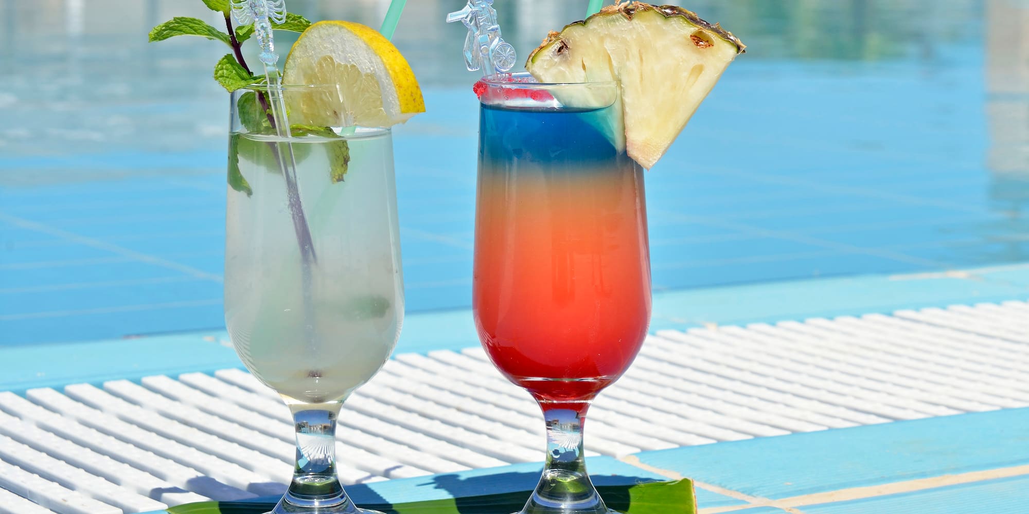 two glasses with drinks on a table